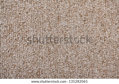 Close up of a new, unused carpet tile in a beige and brown pattern, suitable for modern floor covering at home or in the office