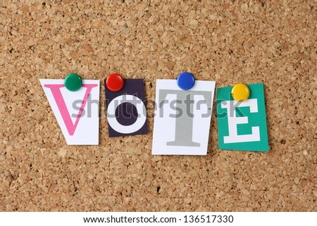 The word Vote in cut out magazine letters pinned to a cork notice board as a concept for democracy and choice