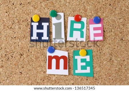 The words Hire Me in cut out magazine letters pinned to a cork notice board as a concept for job hunting and employment The words Hire Me in cut out magazine letters pinned to a cork notice board as a concept for job hunting and employment