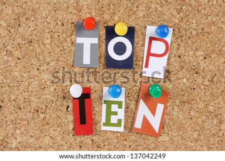 The words Top Ten in cut out magazine letters pinned to a cork notice board
