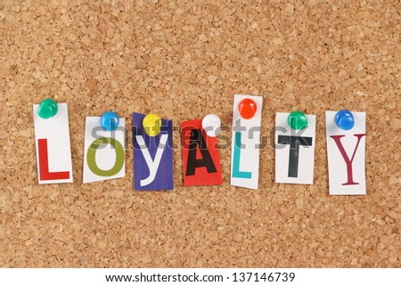 The word Loyalty in cut out magazine letters pinned to a cork notice board. Used in  business the phrase might refer to customer or brand loyalty.