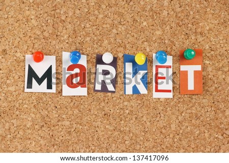 The word Market in cut out magazine letters pinned to a cork notice board. Market can apply to a trading venue or country as well as activities to promote business services or products.