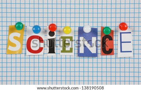 The word Science in cut out magazine letters pinned to a background of blue graph paper