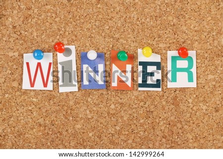 The Word Winner In Cut Out Magazine Letters Pinned To A Cork Notice Board. We Look For Winners In Competitive Sports, Competition And Business.