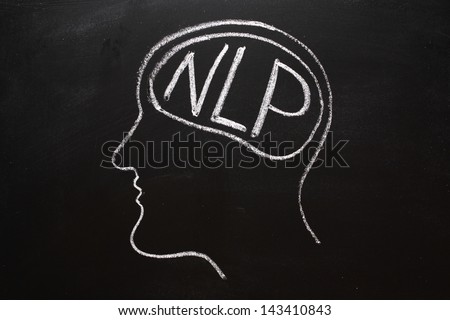Drawing on a blackboard of a human head in profile with NLP on the brain. NLP is the acronym for Neuro-Linguistics Programming, often used in business and Psychotherapy for self improvement.