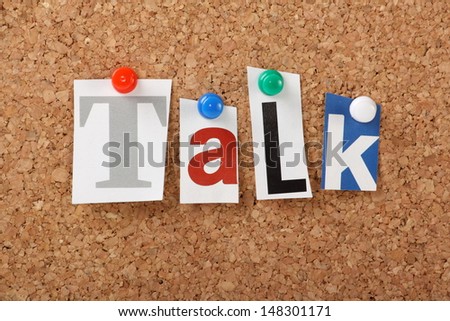 The word Talk in cut out magazine letters pinned to a cork notice board. Talking is an important part of bridging the gap in our professional and personal lives.