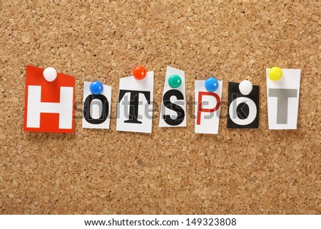 The word Hotspot in magazine letters on a cork notice board. Hotspots are locations in the community that provide wireless internet access or wi-fi for mobile devices such as laptops and smartphones