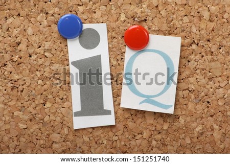 IQ or Intelligence Quotient in cut out magazine letters pinned to a cork notice board.
