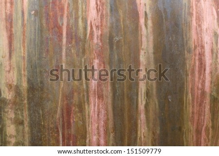 A sheet of copper which has been left outside and rusted by rain water and exposure to the weather