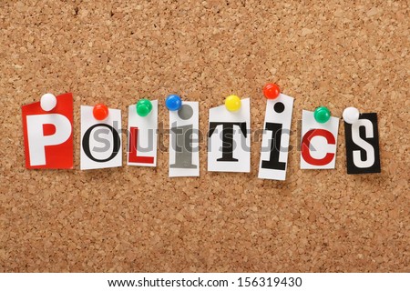 The word Politics in cut out magazine letters pinned to a cork notice board.