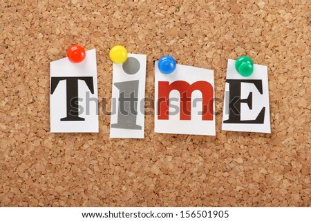 The word Time in cut out magazine letters pinned to a cork notice board