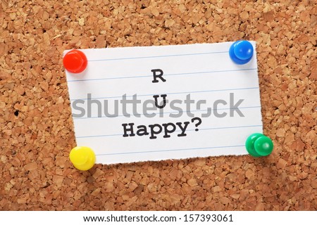 R U Happy typed onto a piece of lined paper and pinned to a cork notice board. We look for happiness in our relationships,work and our daily lives.
