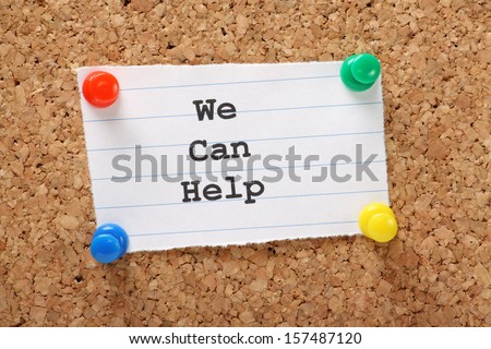 Paper note pinned to a cork notice board with the phrase We Can Help typed onto it