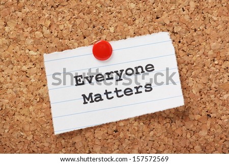The Phrase Everyone Matters Typed Onto A Scrap Of Lined Paper And Pinned To A Cork Notice Board