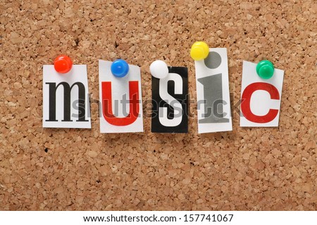 The word Music in cut out magazine letters pinned to a cork notice board.