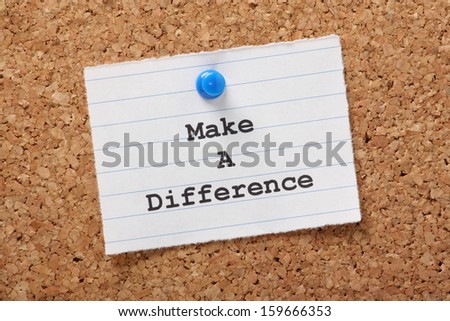 The phrase Make A Difference on a paper note pinned to a cork notice board.