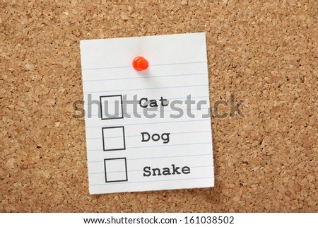 Tick boxes for Dog,Cat and Snake on a cork notice board. We have preferences for animals as pets and some are more unusual or different from the accepted domestic creatures.