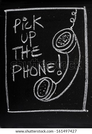 Blackboard concept for fast old fashioned communication avoiding the overuse of email. Pick up the phone written on a blackboard next to a chalk drawing of a telephone handset left dangling