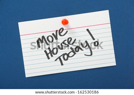A reminder that you Move House Today written on a white note card pinned to a blue notice board.