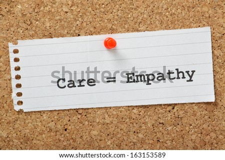 Care equals Empathy typed on a scrap of paper and pinned to a cork notice board. When working in the care profession or caring for someone at home, empathy is key to providing the best support.