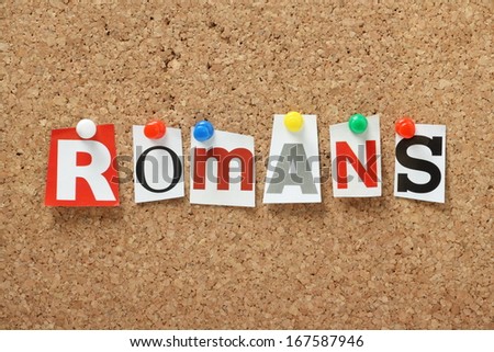 The word Romans, from the Old Testament of the Holy Bible in cut out magazine letters pinned to a cork notice board