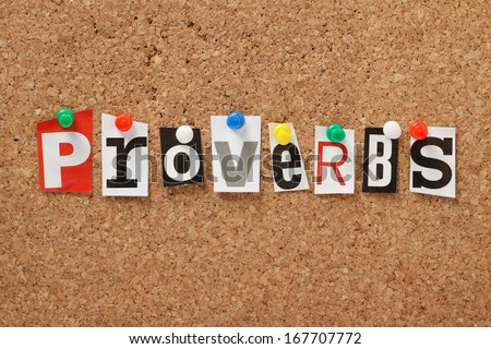 The word Proverbs, one of the books of the Holy Bible in cut out magazine letters pinned to a cork notice board