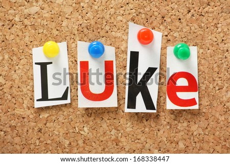 The name Luke, one of the books of the Holy Bible in cut out magazine letters pinned to a cork notice board