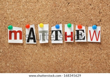 The name Matthew, one of the books of the Holy Bible in cut out magazine letters pinned to a cork notice board