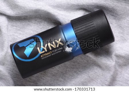BRACKNELL, ENGLAND - JANUARY 05, 2014:  A can of Lynx Attract Deodorant Body Spray for men on a grey cotton background. Lynx products are part of the Unilever group.