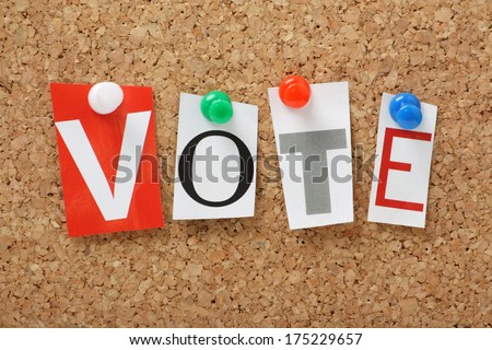 The word Vote in cut out magazine letters pinned to a cork notice board