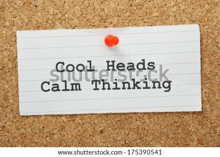 The phrase Cool Heads, Calm Thinking typed on a piece of paper and pinned to a cork notice board