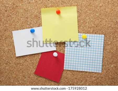 Sticky notes and paper reminders in various colours and styles pinned to a cork notice board. With copy space