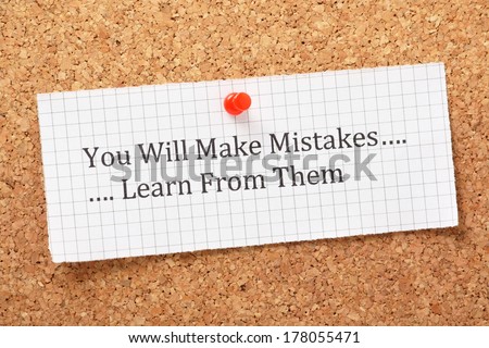 The phrase You Will Make Mistakes, Learn From Them typed on a piece of graph paper and pinned to a cork notice board. A way of empowering people on their road to success.
