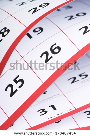 A close up view of the open pages of a calendar with the date numbers visible