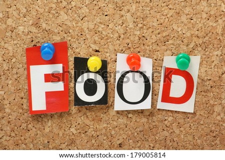 The word Food in cut out magazine letters pinned to a cork notice board