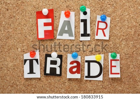 The phrase Fair Trade in cut out magazine letters pinned to a cork notice board