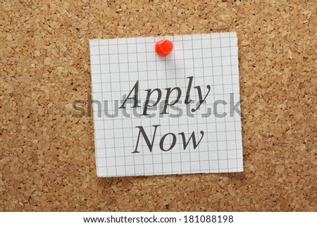 The phrase Apply Now typed on a piece of graph paper and pinned to a cork notice board
