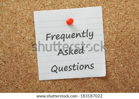 The phrase Frequently Asked Questions typed on piece of lined paper and pinned to a cork notice board