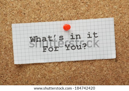 The question What\'s In It For You typed on a piece of graph paper and pinned to a cork notice board