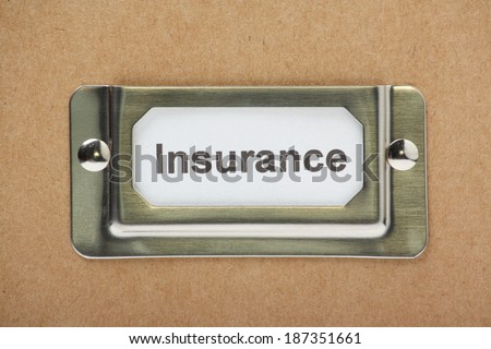 A cardboard box or drawer for storage of your Insurance documents with a label in a metal holder on the front