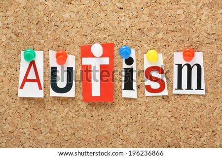 The word Autism in cut out magazine letters pinned to a cork notice board