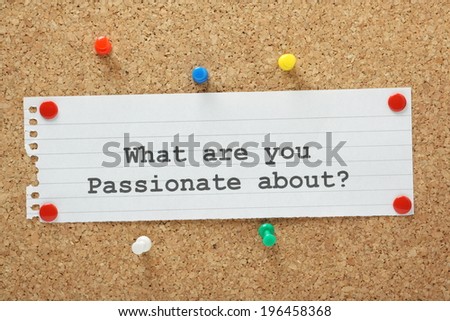 The question What Are You Passionate About typed on a paper note and pinned to a cork notice board.