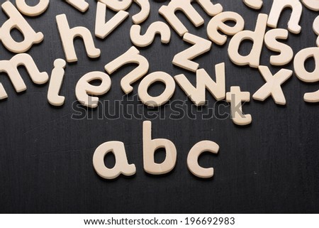Wooden letters arranged to spell abc for the alphabet on a blackboard