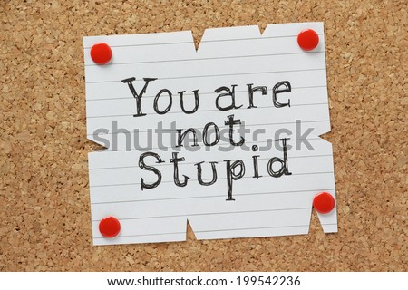 The phrase You Are Not Stupid written by hand on a piece of paper pinned to a cork notice board