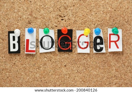 The word Blogger in cut out magazine letters pinned to a cork notice board
