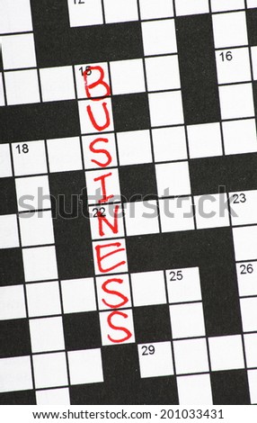 The word Business written in red ink on a newspaper crossword puzzle