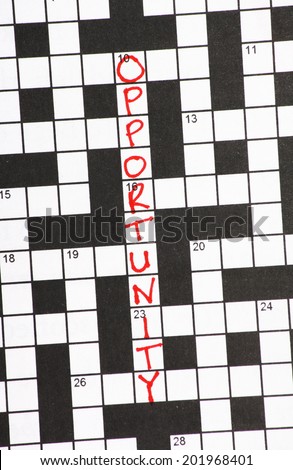 The word Opportunity written in red ink on a newspaper crossword puzzle