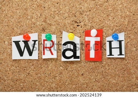 The word Wrath, one of the seven deadly sins in cut out magazine letters pinned to a cork notice board