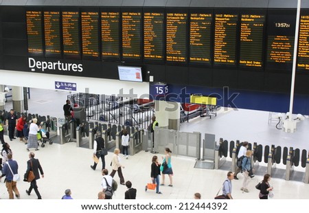 London, UK - Aug 21: The main departures board and concourse at Waterloo Railway Station on 21st August, 2014. Based on people entering or leaving, Waterloo has almost 96m users per year
