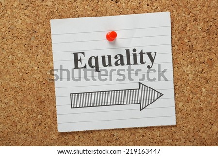 The word Equality above an arrow pointing in the right direction on a lined paper note pinned to a cork notice board